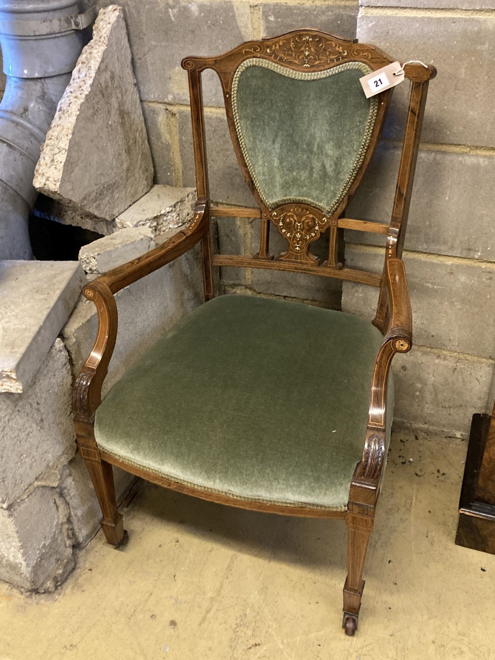An Edwardian bone and marquetry-inlaid rosewood elbow chair, on square tapered legs with castors, width 55cm, height 89cm